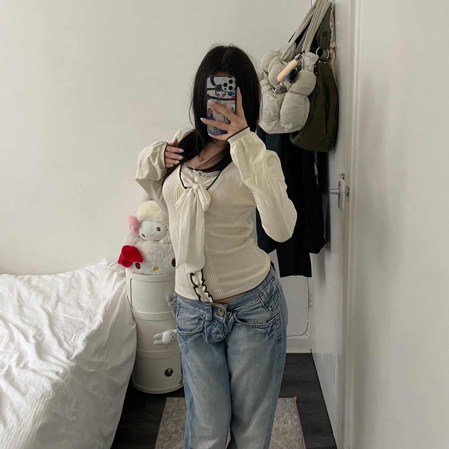 cream glacier long sleeve top with black lettuce trim and cream chiffon bow