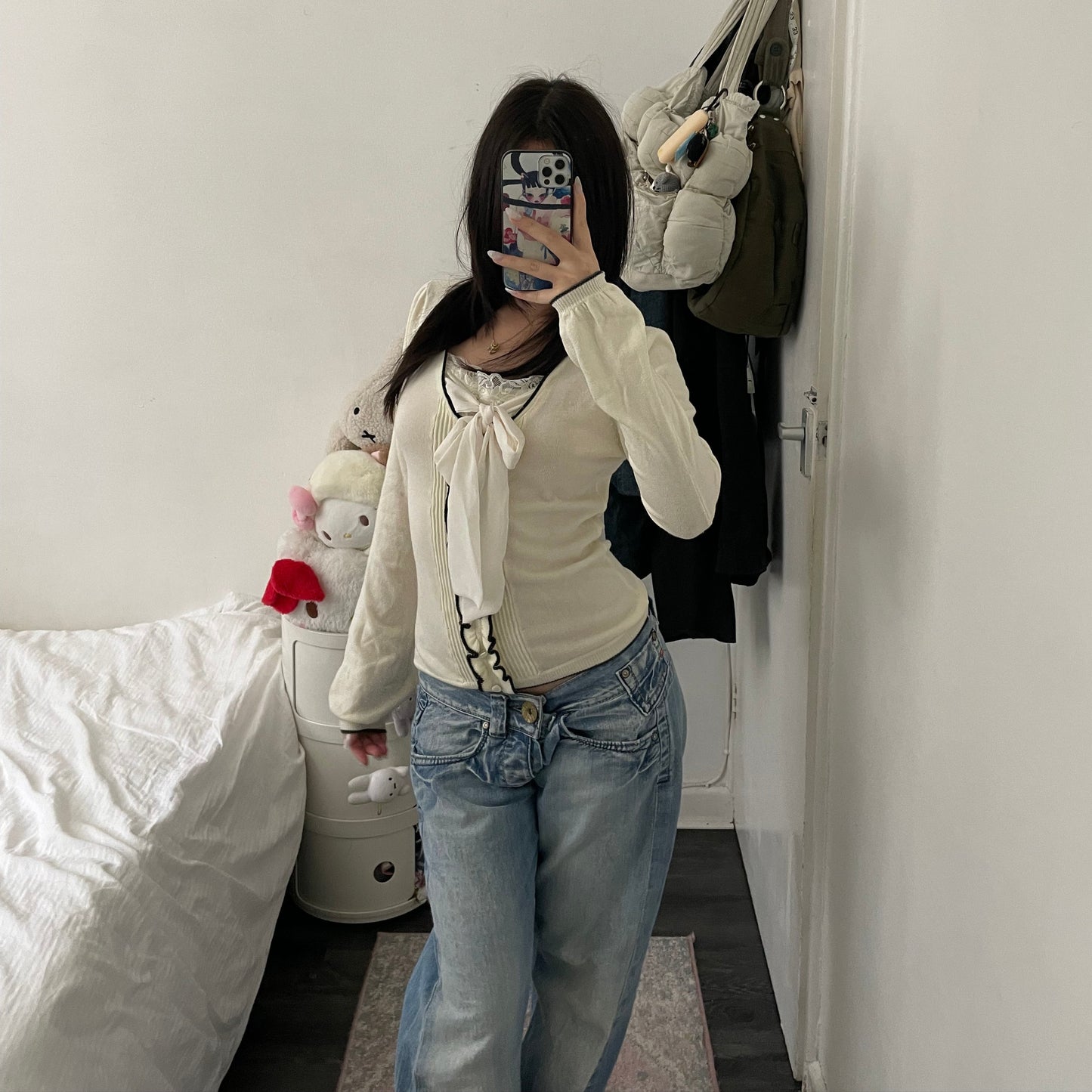 cream glacier long sleeve top with black lettuce trim and cream chiffon bow
