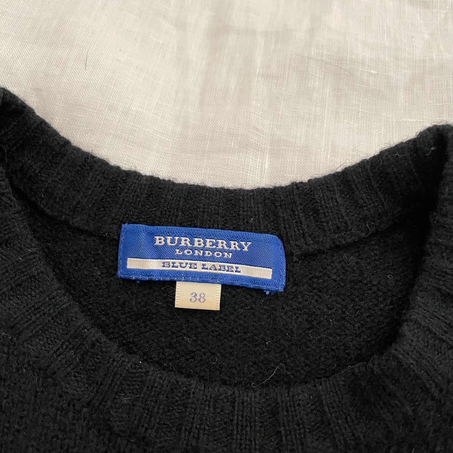 burberry blue label preppy black wool short sleeve knit top with grey italic text