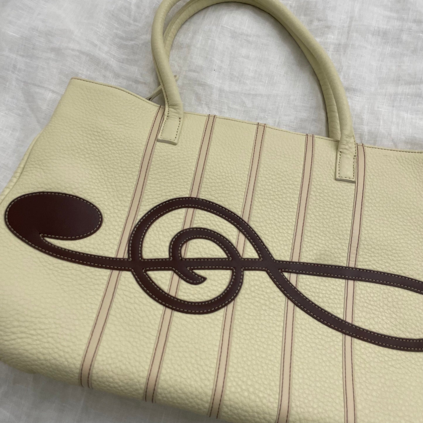 rare music for living cream leather treble note shoulder bag