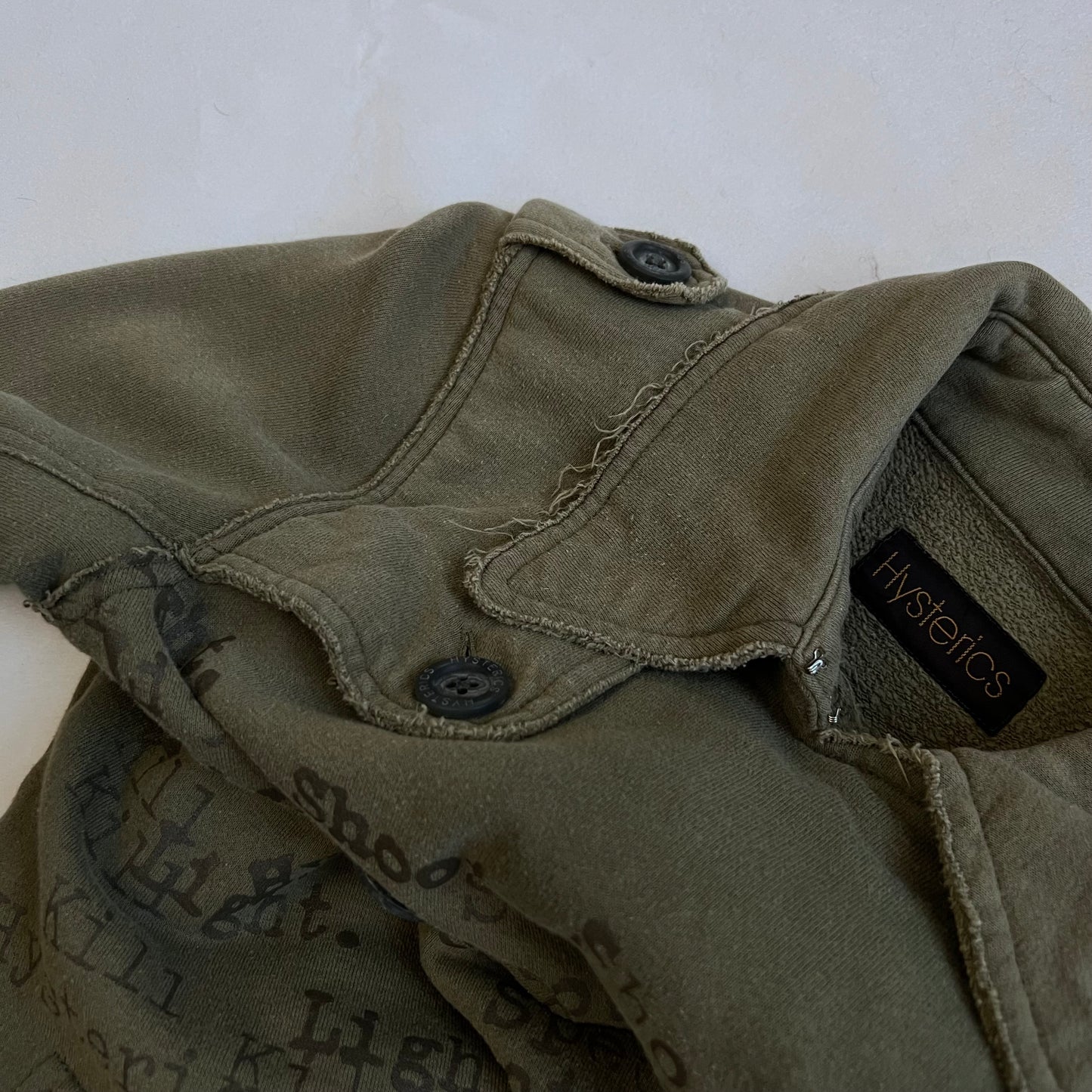 hysterics khaki corpcore asymmetric button faded text graphic collared jacket