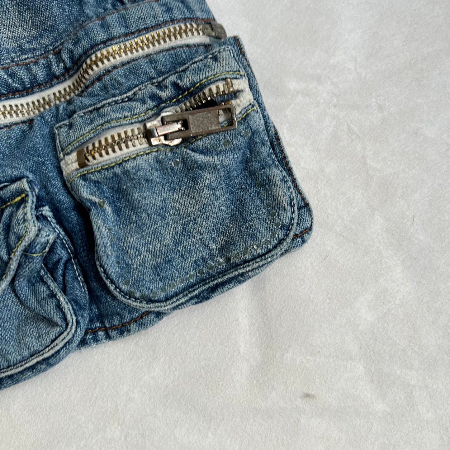 baci denim light wash utility deconstructed hanging zip pocket cargo denim mini skirt