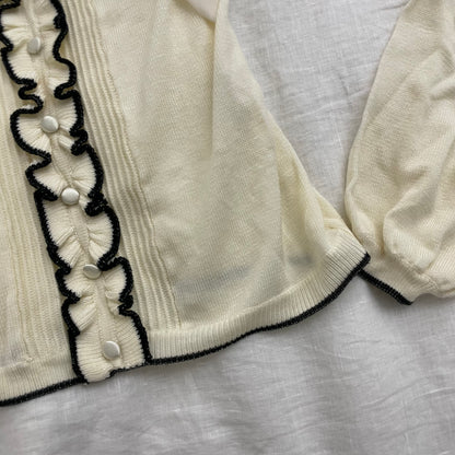 cream glacier long sleeve top with black lettuce trim and cream chiffon bow