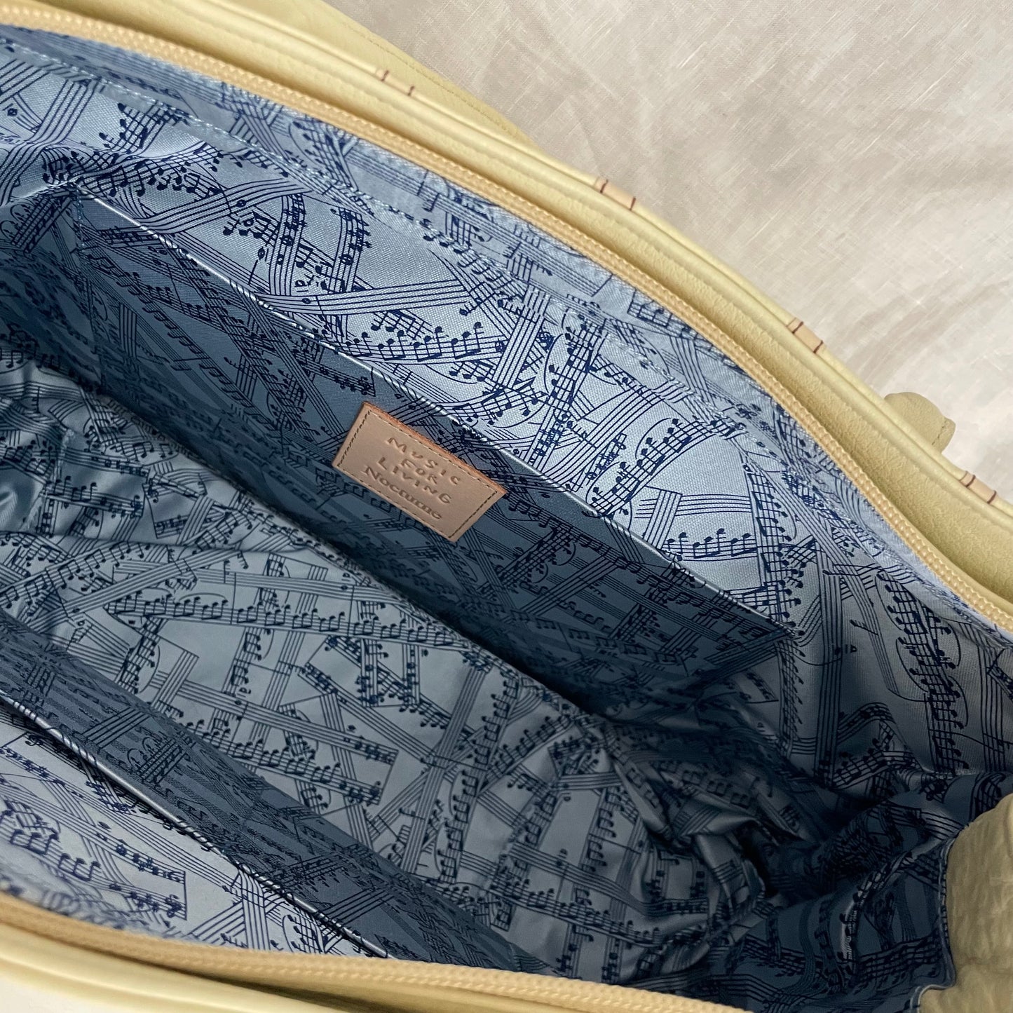 rare music for living cream leather treble note shoulder bag