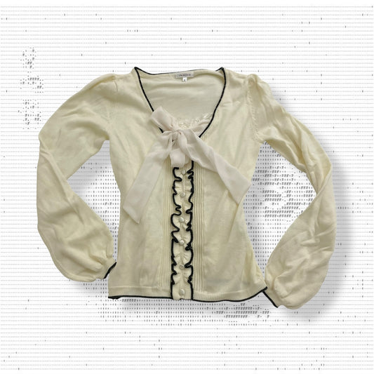 cream glacier long sleeve top with black lettuce trim and cream chiffon bow